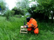 Riding dino toy in garden wearing hivis and rubber boots