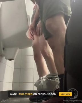 2 Boys in Sneakers Having Fun at Public Toilets' Urinal
