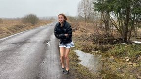 A girl in ballet flats walks through puddles and gristles, changes them