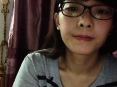 Nerdy young cock-lover takes her top off and teases the cam