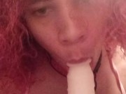 Cute crossdresser in pink sucks dildo