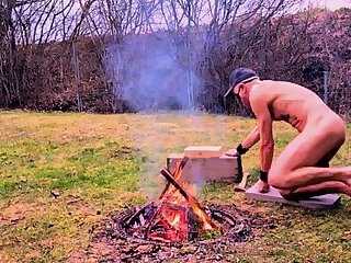 naked pathetic slave outdoor prepare campfire first time this year for BDSM party