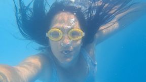 Blowing bubbles underwater with goggles