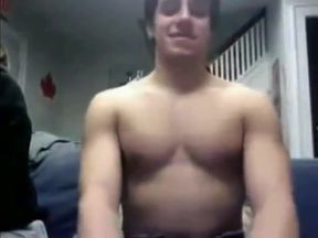 Straight hockey player giving a webcam show with team friends looking on