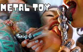 Oiled up Lesbians Share a Metal Toy