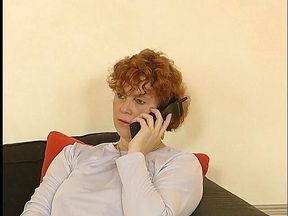 Mature lady is having a phone call