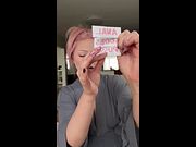 Pink-haired tease holds up dirty card and bites her lip