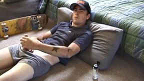 Dan gets down on the floor and starts watching a porn video. He goes right for his cock and plays with himself until he's boned up. Rolling the head with his palm, Dan lubes up his hot dick.