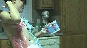 Cute Asian brunette girl coats her curves with whipped topping