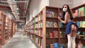 Asian cutie flashes her petite shaved pussy in a gorgeous bookstore