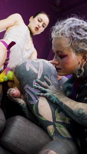Heavy Tattooed Sub Played with and Pegged by 2 Dominas