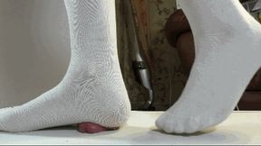 A cock under the feet in socks