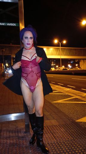 Sexy transvestite Taniax in hot red body lingerie standing on the Avenue