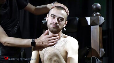Submissive man masked and electrified on a bondage chair
