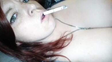 Big tits redhead smokes gets frisky rubbing her shaved pussy