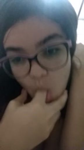 Touching herself and moaning quietly so her parents don't hear her