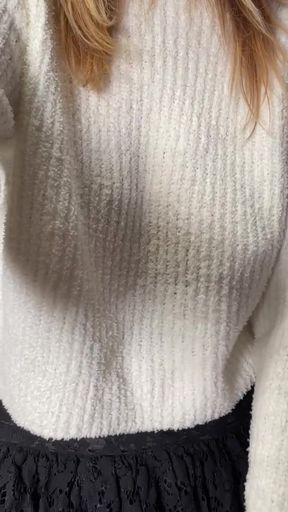 Blonde woman in white sweater and skirt