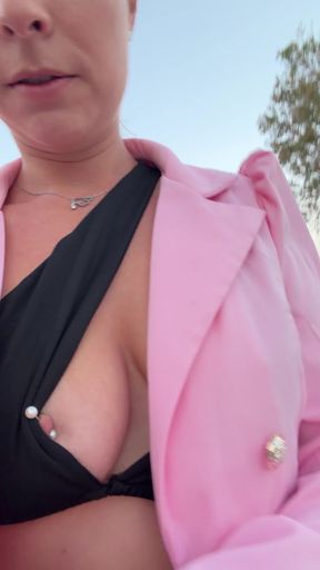 Woman with erect nipples flashes her nipple piercing in public while wearing a d
