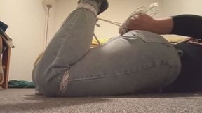 Crossdresser tied in jeans walking in the room