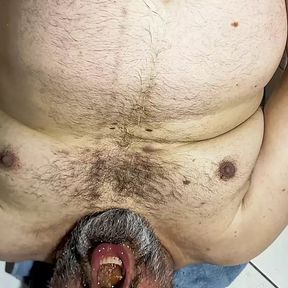 Bearded bear pissing in his mouth and drinks it