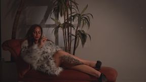Smoking cigerettes in a fur coat and lingerie