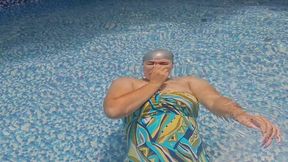 Helpless mermaid holding her breath underwater