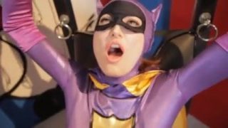 Batgirl and Catwoman cosplayers playing with vibrators