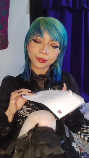 Blue-haired woman holding a card