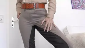 German lady presses slave's ass in tight jodhpurs