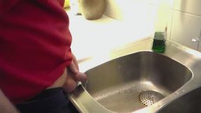 John is Peeing in the Kitchen Sink