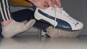 Young sneaker master use Puma Drift Cat to crush bag of chips