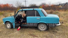 Anastasia revving old VAZ in her high heels and shiny outfit