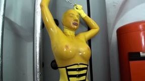 Girl in yellow latex catsuit and fishnets - Self bondaged