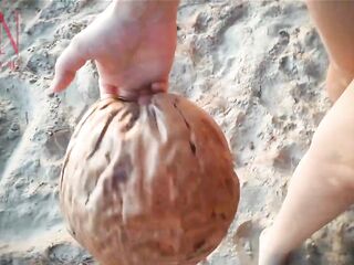 Good lady at lonely nudist beach. Red swimsuit. Red bikini. Coconut