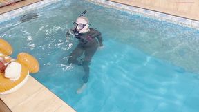 Alla wears a wetsuit and a diving mask and swims in the pool and fucks an inflatable reindeer that suddenly pops