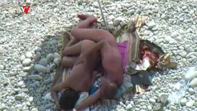 beach voyeur. a girl relaxes on a nudist beach with a dick in her pussy