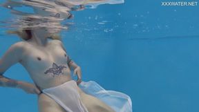 Finnish girl sunbathes and swims naked in the pool