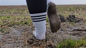 Walking on Muddy Field in White Socks