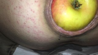 Removing an apple stuck in a pigs backside