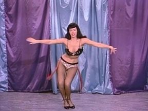 Classic brunette domina with whip shows off her body