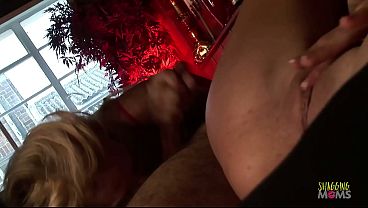 The men and brunettes get a visit from the blonde milf who they welcome with anal group sex