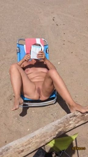 Exhibition on the beach. She tans her pussy. Cap d'Agde