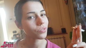 Tempting Italian girl smokes a cigar in a close up video