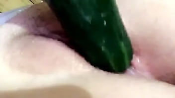 Stretching wet pussy with cucumber