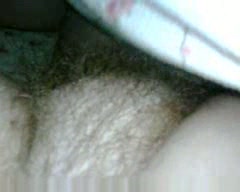 Playing with her hairy snatch and pink nipples on cam