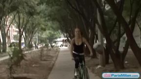 Busty solo teen riding her bike through the park