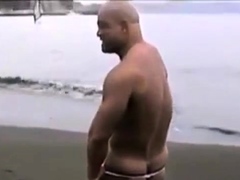 Asian bodybuilder barely covered at the beach