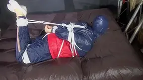 Watch Sandra Hogtied And Pantygagged In Her Shiny Nylon Rainwear Trying To Free Herself.