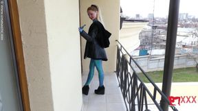 Contortion on the balcony in sexy spandex catsuit
