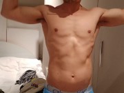 stripping and flexing through my hoodie, tanktop, briefs flexing my muscles
